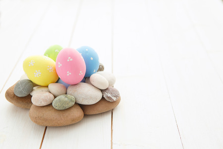 Colorful decorated easter eggs on white wood background. Happy Easter.の写真素材