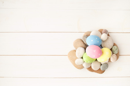 Colorful decorated easter eggs on white wood background. Happy Easter.の写真素材