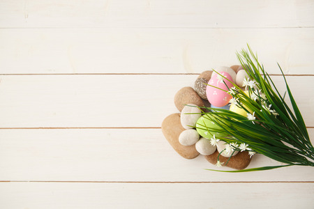 Colorful decorated easter eggs on white wood background. Happy Easter.の写真素材