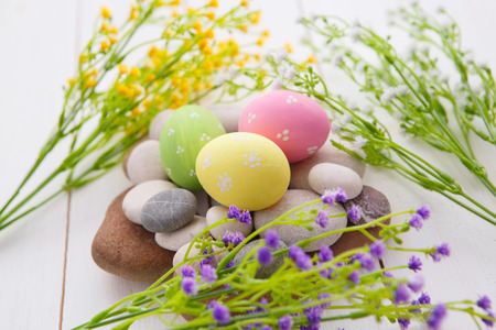 Colorful decorated easter eggs on white wood background. Happy Easter.の写真素材