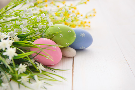 Colorful decorated easter eggs on white wood background. Happy Easter.の写真素材
