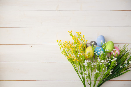 Colorful decorated easter eggs on white wood background. Happy Easter.の写真素材