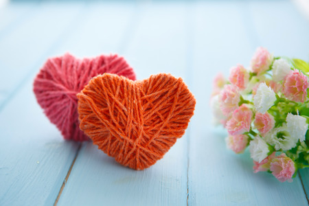 sign with hearts and spring tree blossoms hanging on wood backgroundの写真素材