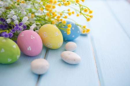 Colorful decorated easter eggs on white wood background. Happy Easter.の写真素材