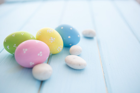Colorful decorated easter eggs on white wood background. Happy Easter.の写真素材