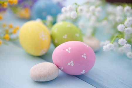 Colorful decorated easter eggs on white wood background. Happy Easter.の写真素材