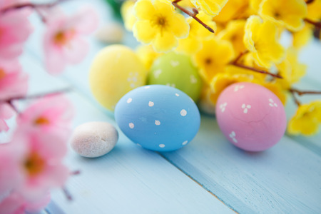 Colorful decorated easter eggs on flowers background. Happy Easter.の写真素材