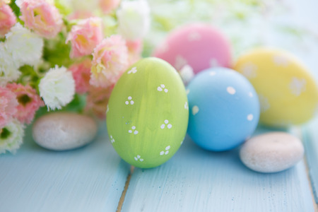 Colorful decorated easter eggs on white wood background. Happy Easter.の写真素材