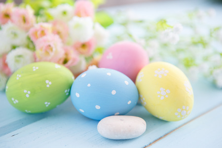 Colorful decorated easter eggs on white wood background. Happy Easter.の写真素材