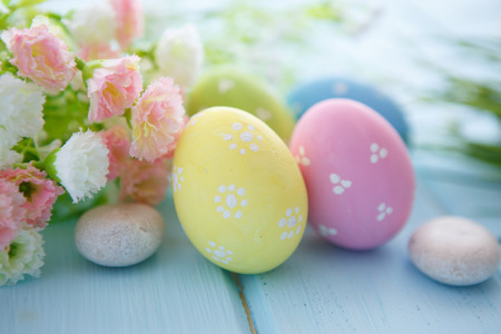 Colorful decorated easter eggs on white wood background. Happy Easter.の写真素材