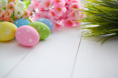 Colorful decorated easter eggs on white wood background. Happy Easter.の写真素材