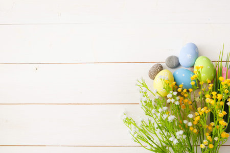 Colorful decorated easter eggs on white wood background. Happy Easter.