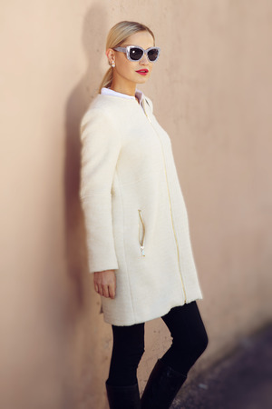 Young fashion business woman in sunglasses on a city streetの写真素材