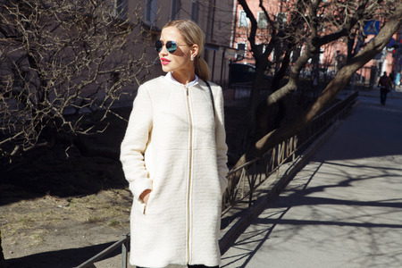 Young fashion business woman in sunglasses on a city streetの写真素材