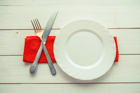 Knife and fork over wooden table with copy space. Diet Food concept.の写真素材
