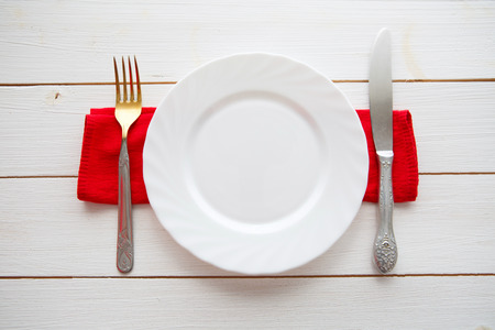 Knife and fork over wooden table with copy space. Diet Food concept.の写真素材