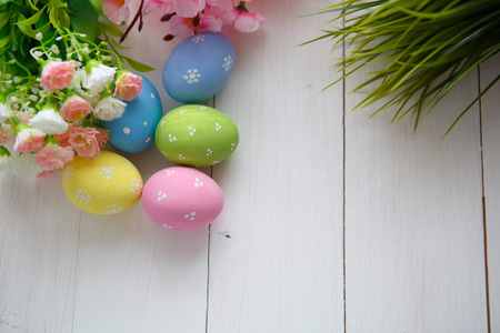 Colorful decorated easter eggs on white wood backgroundの写真素材