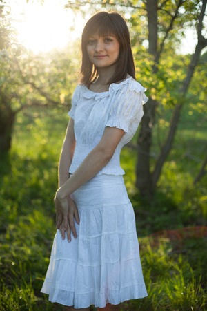 portrait of young brunette in the spring gardenの写真素材