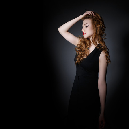 Beautiful  Woman on the Dark Background of Dark Wallの写真素材