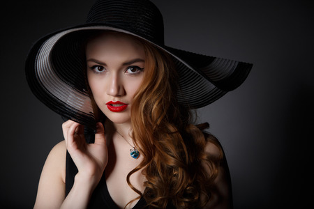 Very Beautiful  Woman on the Dark Background of Dark Grey Wallの写真素材