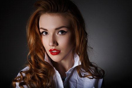 Beautiful Lonely Woman on the Dark Background of Dark Wallの写真素材