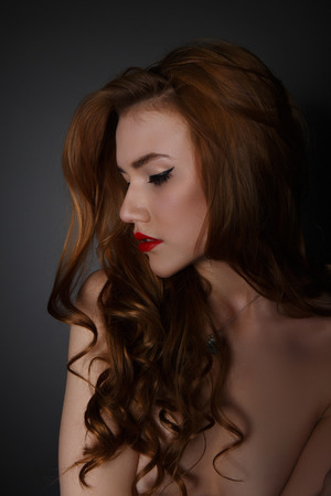 Beautiful  Woman on the Dark Background of Dark Wallの写真素材