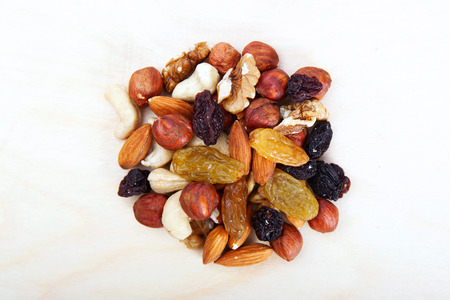 A handful of trail mix isolated on white. Big pile of different nuts lying  on a white background.の写真素材