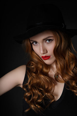 Beautiful Lonely Woman on the Dark Background of Dark Wallの写真素材