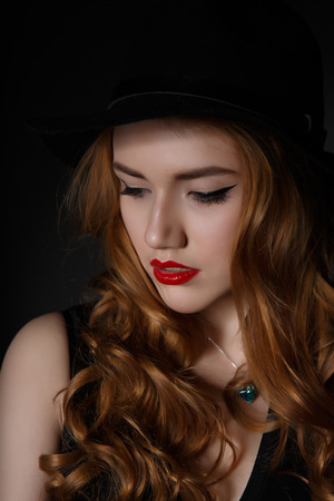 Beautiful Woman on the Dark Background of Dark Wallの写真素材
