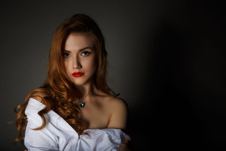 Beautiful Woman on the Dark Background of Dark Wall