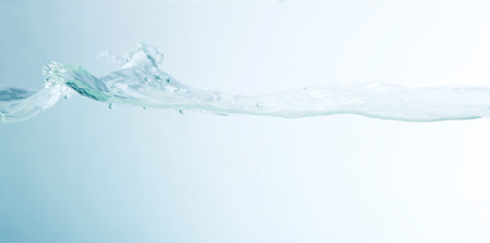 Close up of splash of water isolated on background.の写真素材