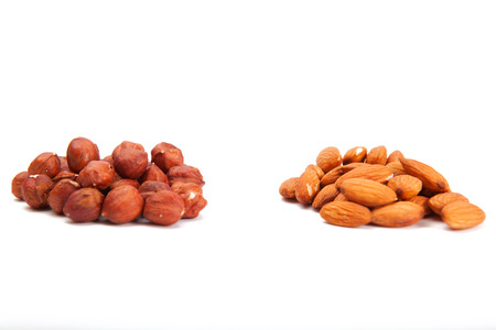 Pile of assorted nuts on white. Heap hazelnut and almonds  on a white background.の写真素材