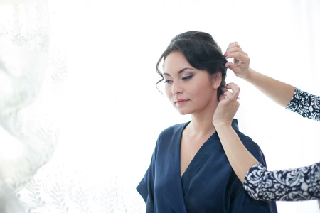 bride being made up by make up artistの写真素材