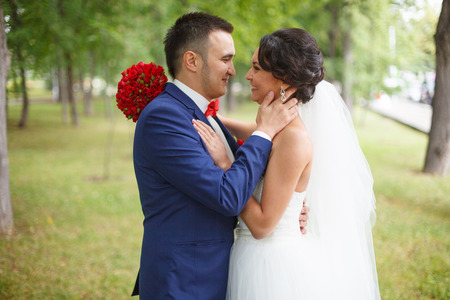 Wedding shot of bride and groom in park.の写真素材