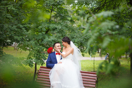 Wedding shot of bride and groom in park.の写真素材