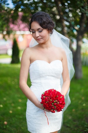 Beautiful young bride in a park.の写真素材