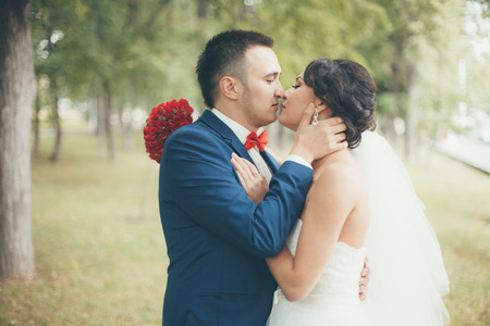 Bride and groom kissing at wedding ceremonyの写真素材