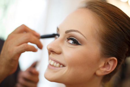 Horizontal photo of bride being made up by make up artistの写真素材