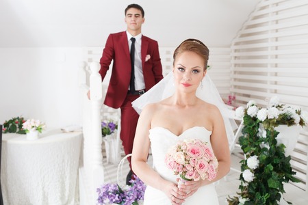 beautiful young bride and groom stand togetherの写真素材