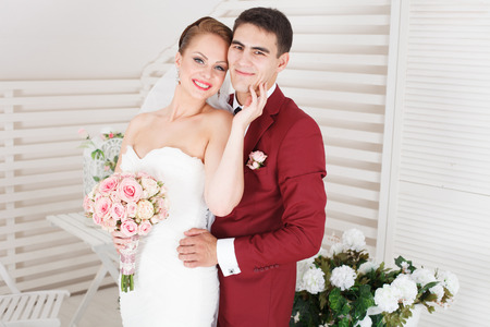 beautiful young bride and groom stand togetherの写真素材