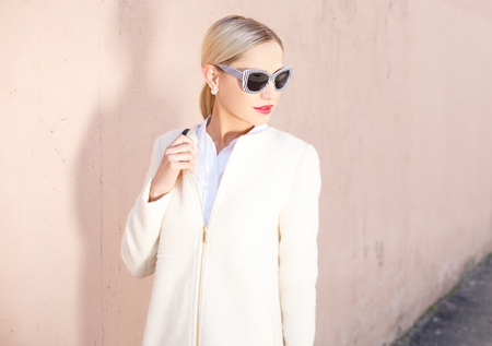 Young fashion business woman in sunglasses on a city streetの写真素材