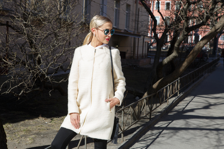 Young fashion business woman in sunglasses on a city streetの写真素材