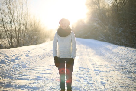 Happy female in winter forestの写真素材