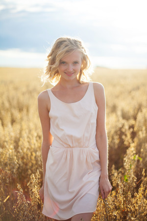 Woman portrait in a fieldの写真素材