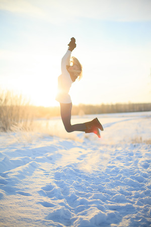 Happy female in winter forestの写真素材
