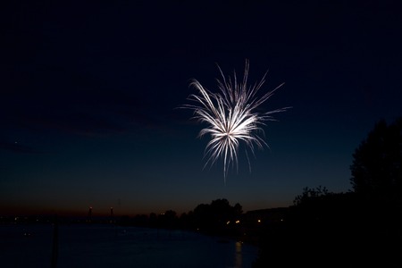 Beautiful colorful holiday fireworks in the evening sky with majestic clouds,  long exposureの写真素材