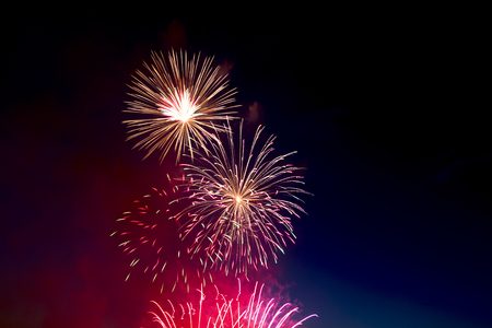 Beautiful colorful holiday fireworks on the black sky background,  long exposure