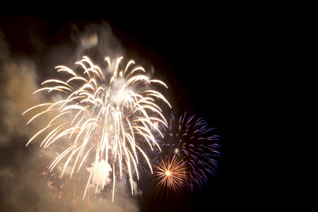 Brightly colorful fireworks and salute of various colors in the night skyの写真素材