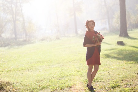 beautiful woman in the morning mist in autumn forestの写真素材