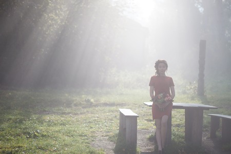 beautiful woman in the morning mist in autumn forestの写真素材